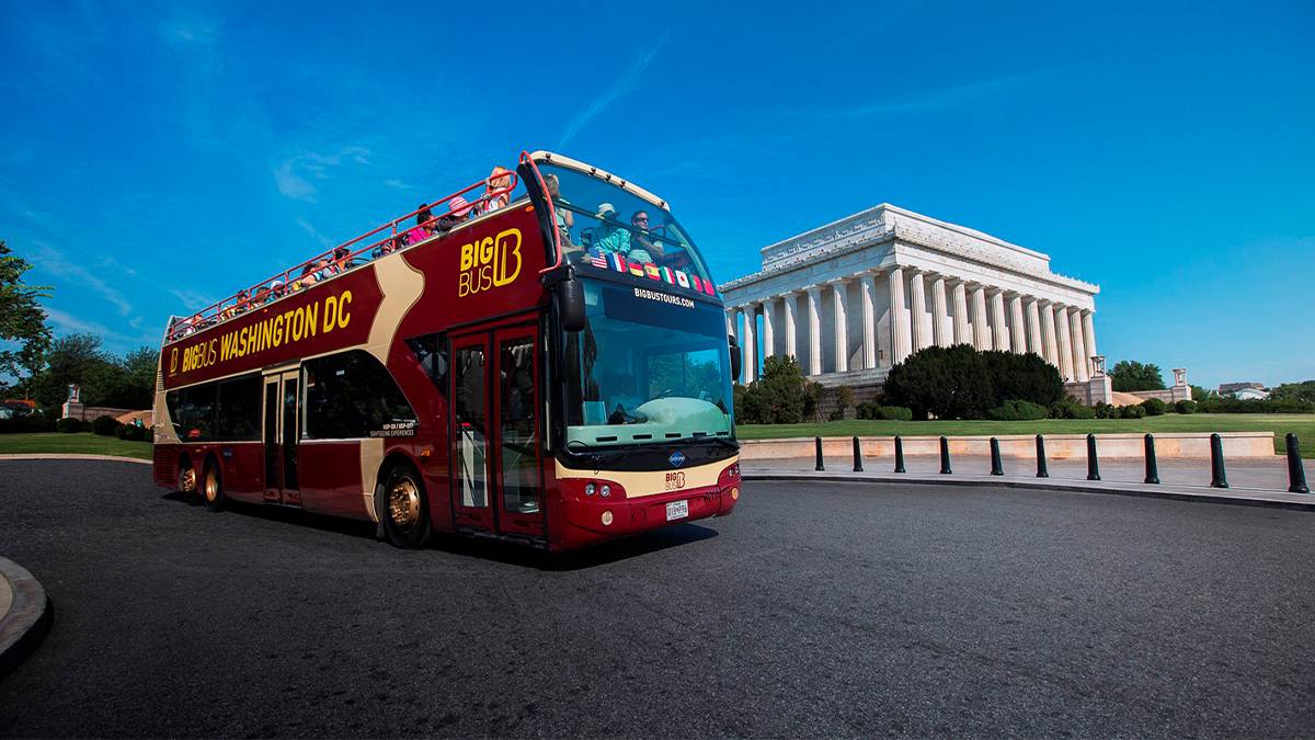 A Bug Bus tour bus driving in front of the Lincoln Memorial on a sunny day in Washington, DC, USA